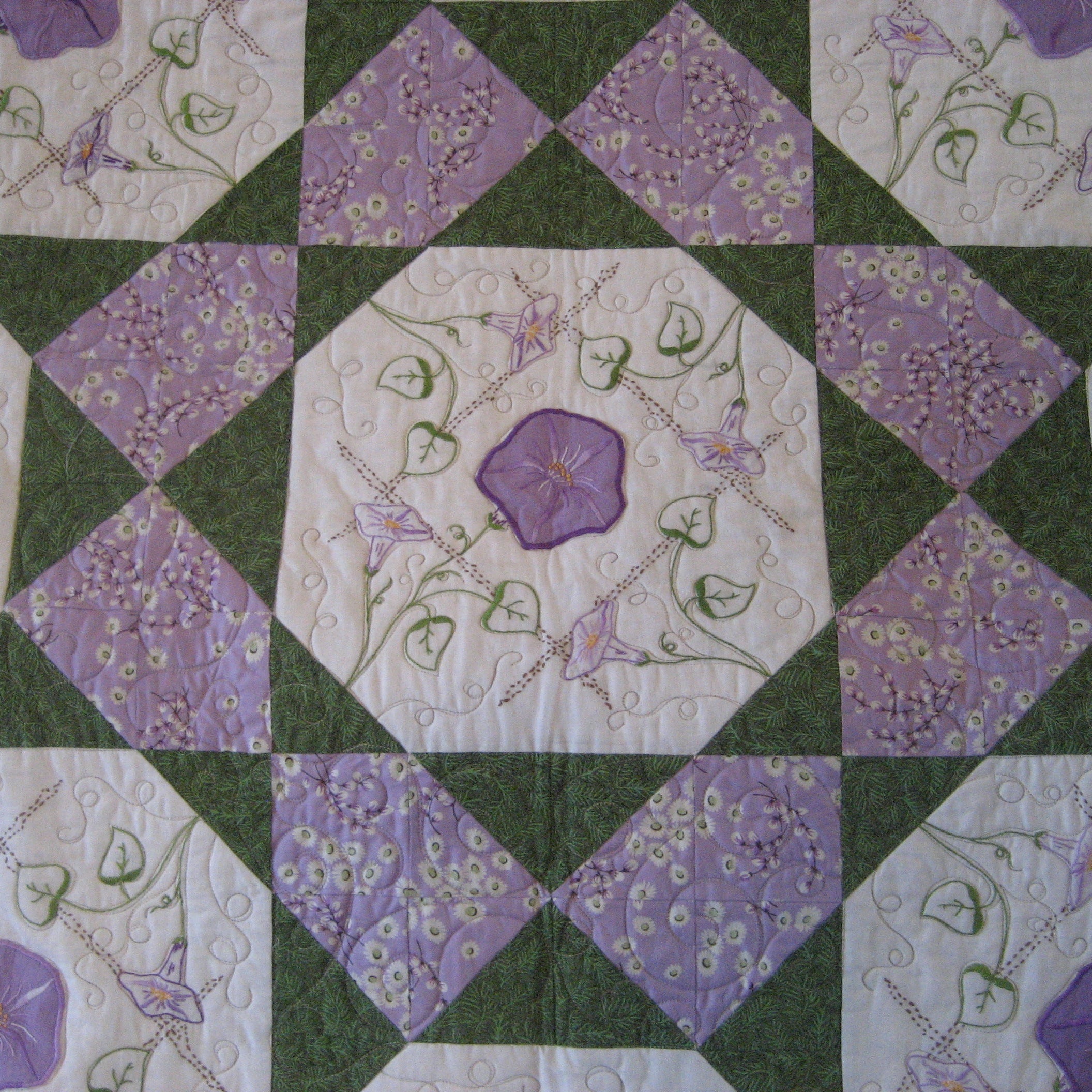 Quilt block in purple and green with a floral print