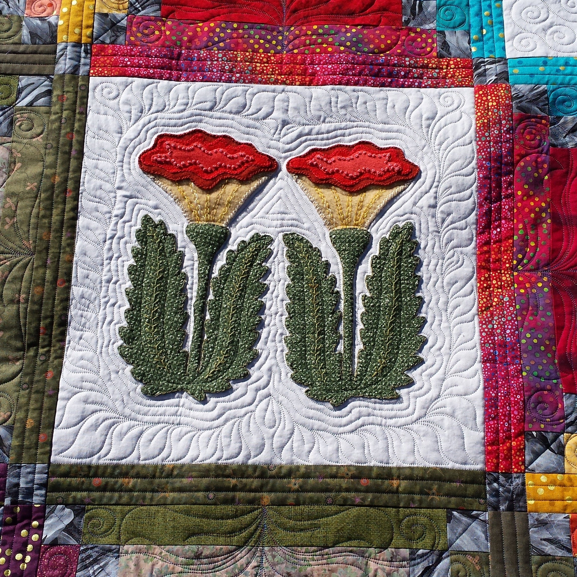 Quilt with floral design and colorful border