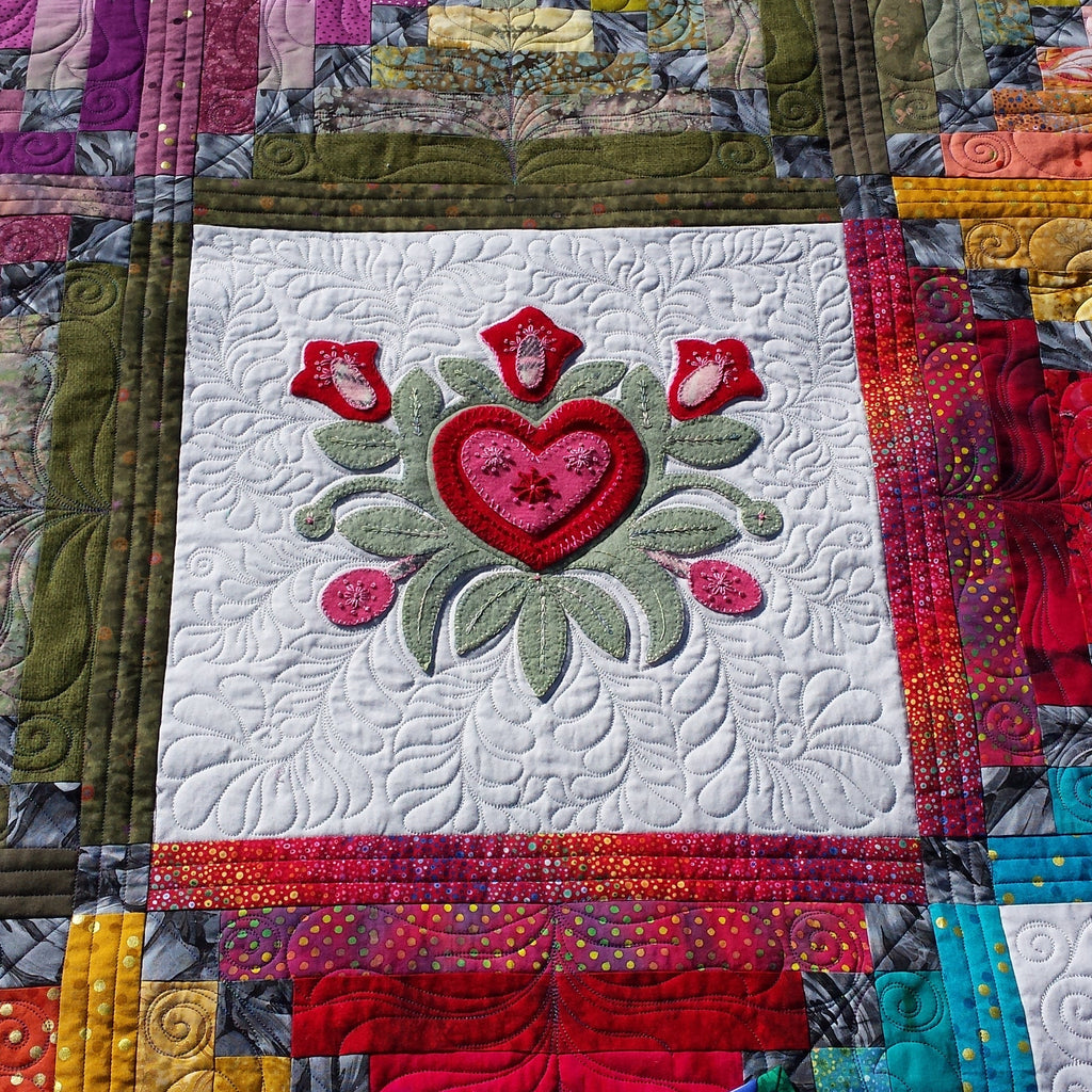Colorful quilt with a heart design in the center