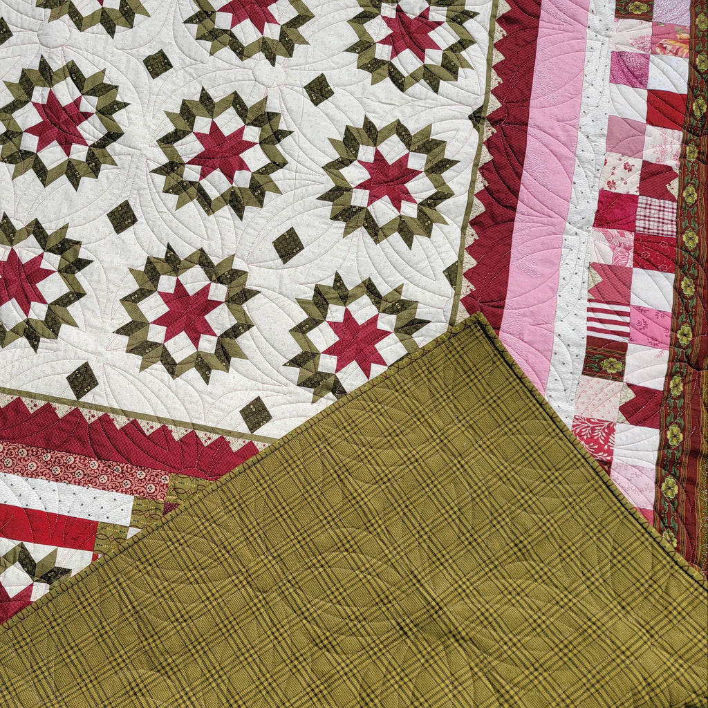 Quilt with star pattern in red, green, and white