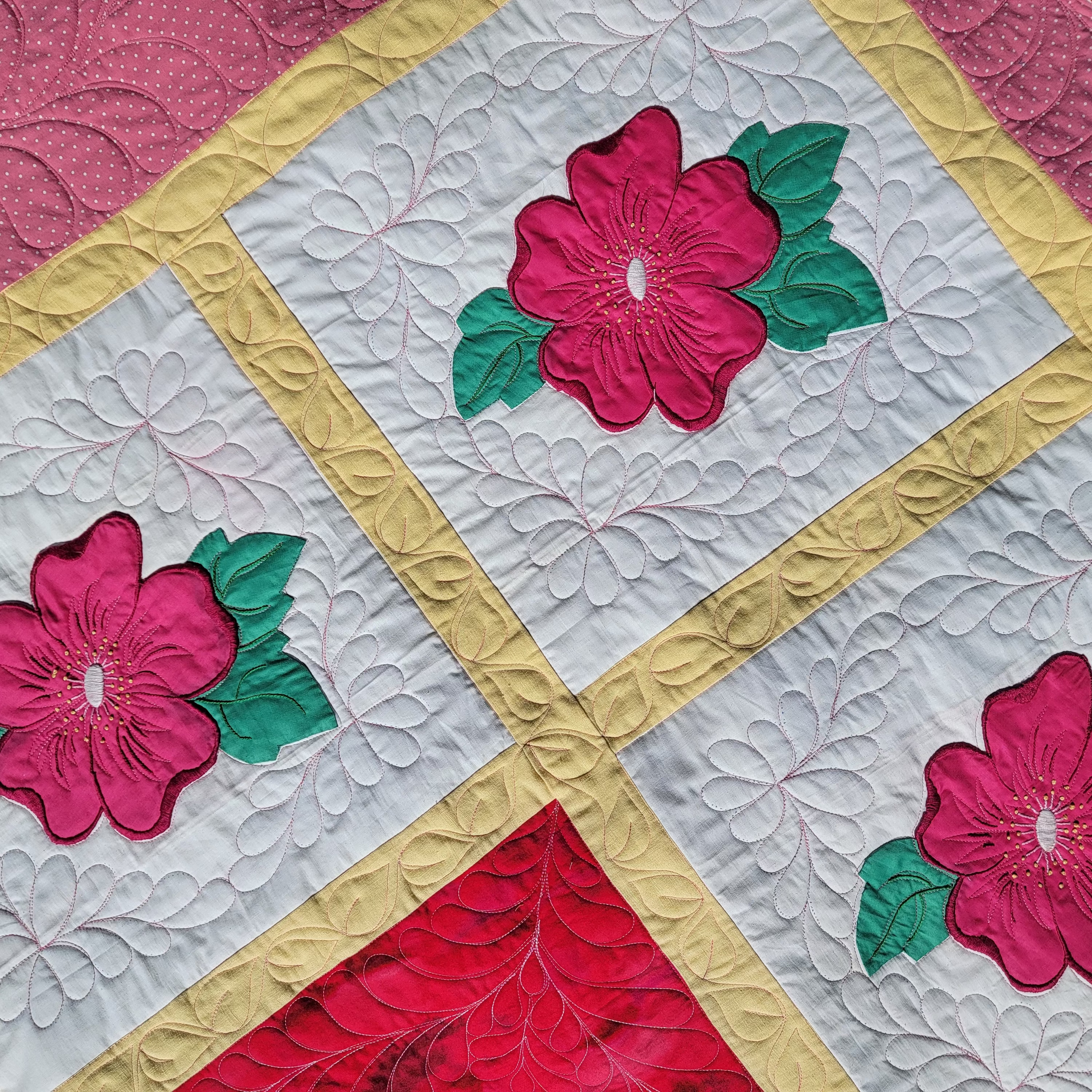 Quilt with floral patterns and colorful borders