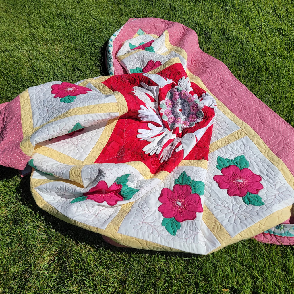 Quilt with floral patterns on grass