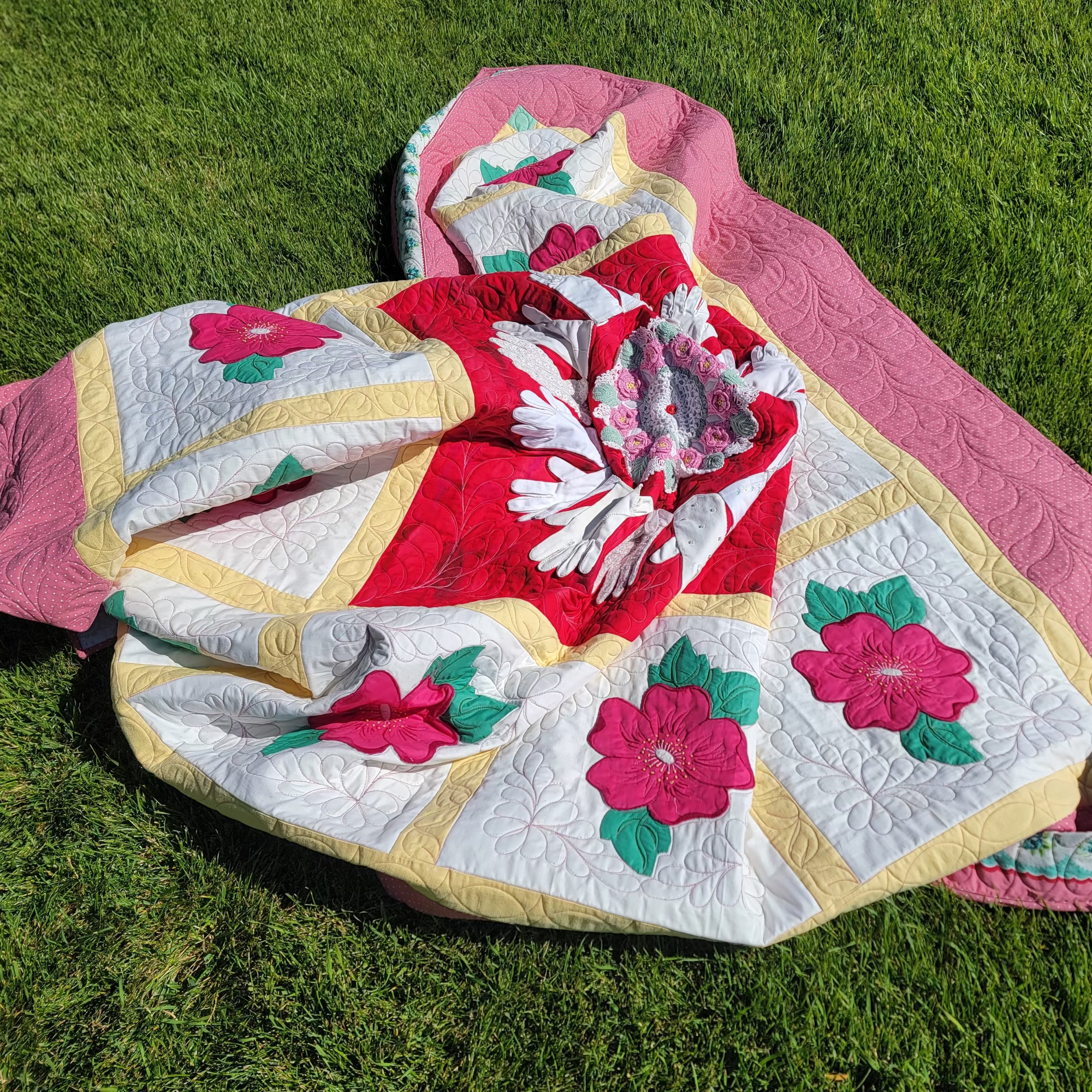Quilt with floral patterns on grass