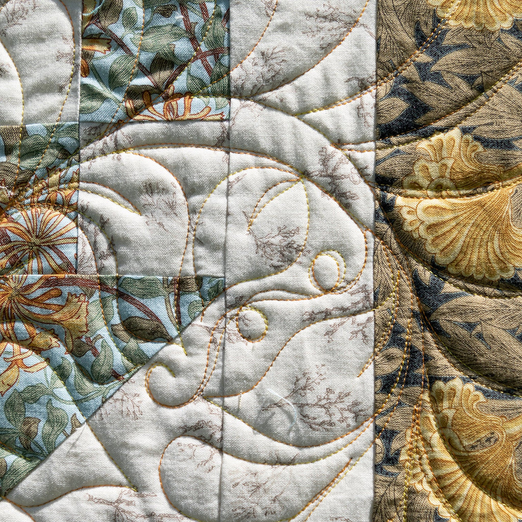 Close-up of a textured fabric with floral patterns in earthy tones.