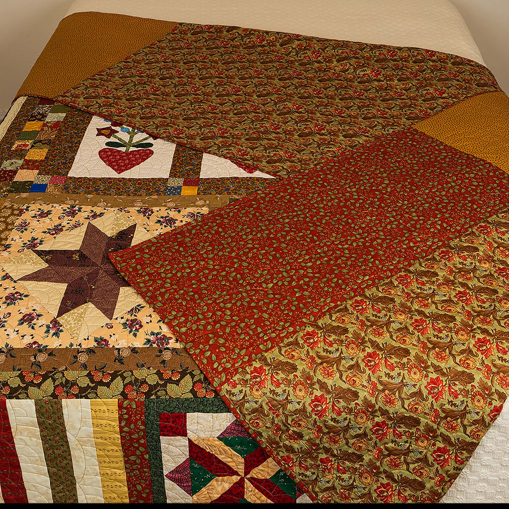 Quilt with various patterns on a bed