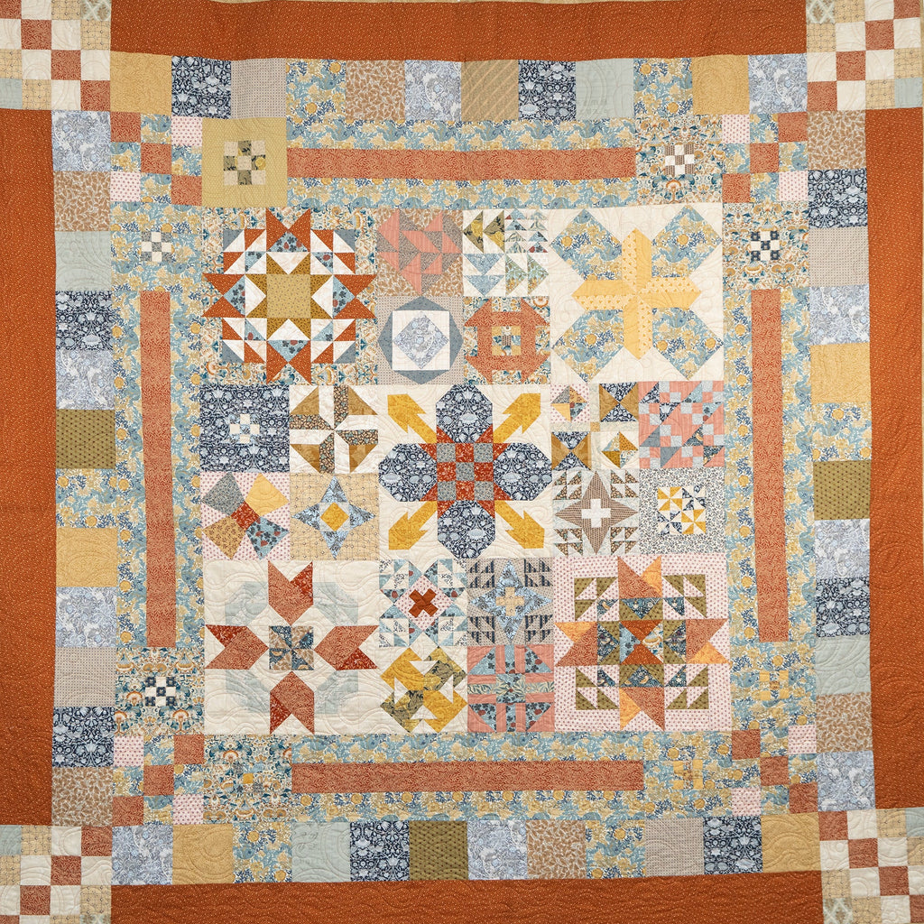 Colorful patchwork quilt with geometric patterns on a white background