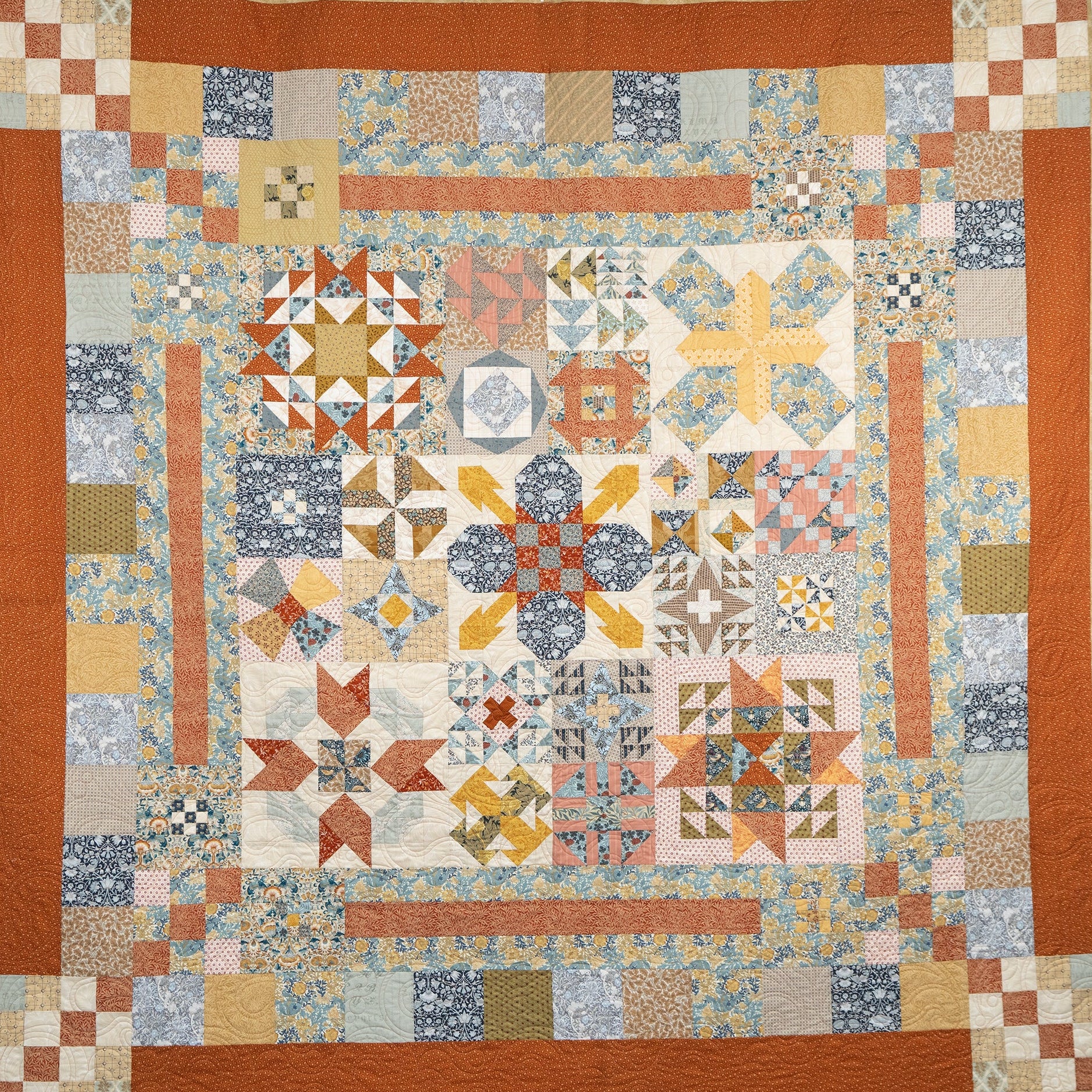 Colorful patchwork quilt with geometric patterns on a white background