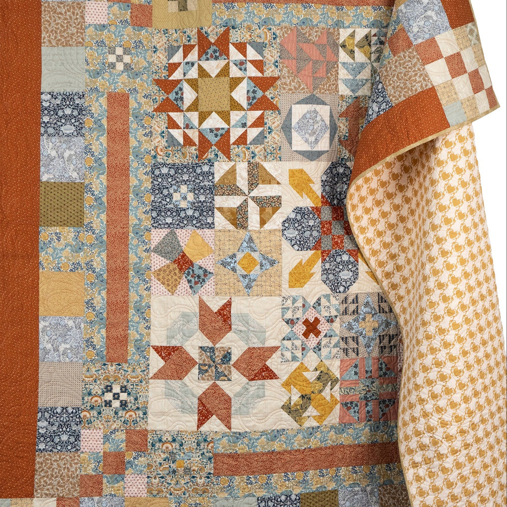 Colorful quilt with geometric patterns on a white background