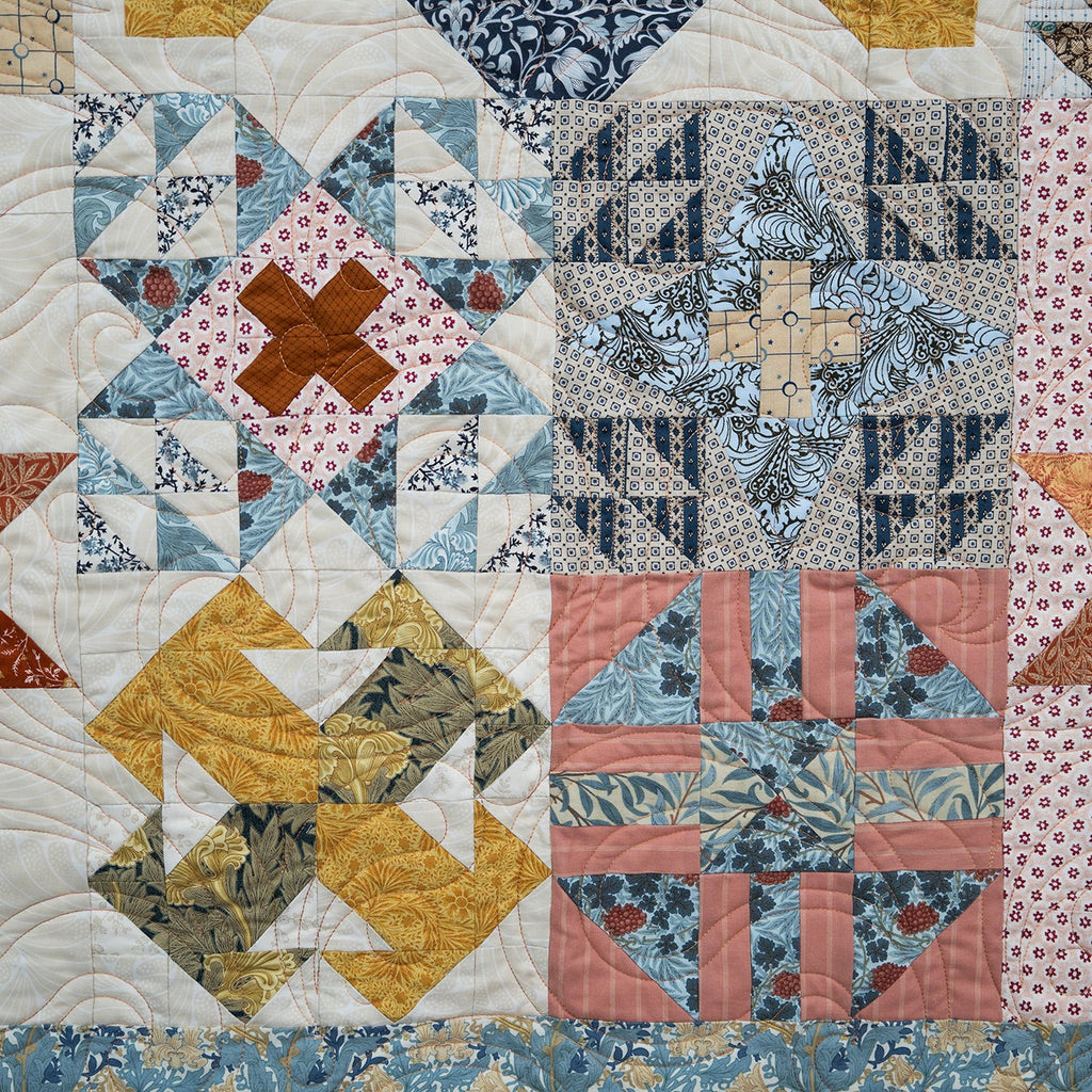 Quilt with patchwork pattern featuring various colors and shapes