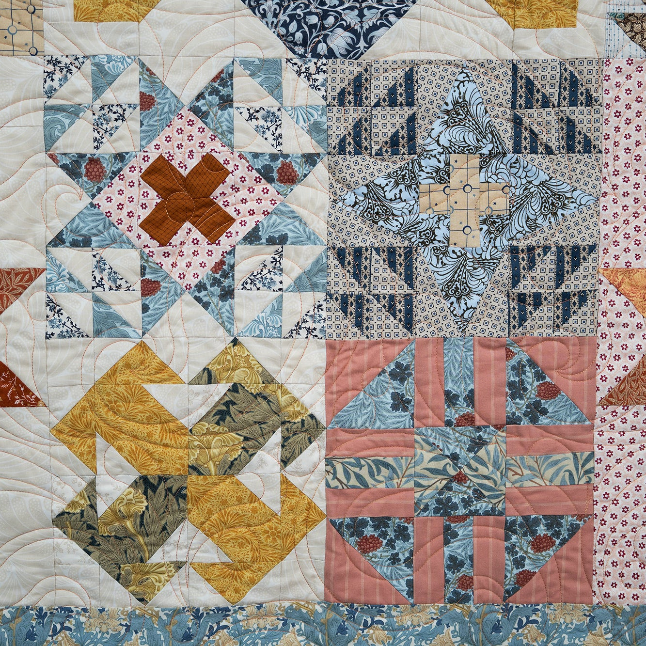 Quilt with patchwork pattern featuring various colors and shapes