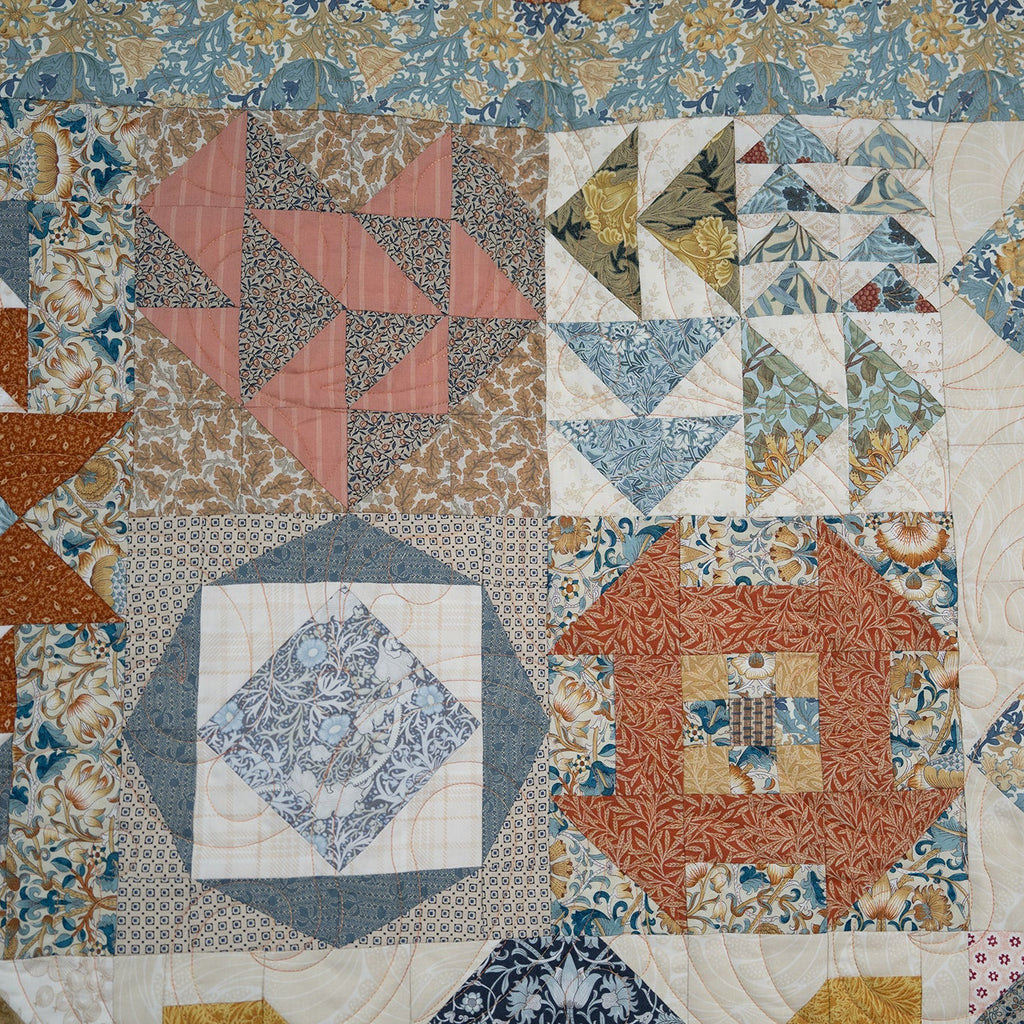 Patchwork quilt with various geometric patterns and colors