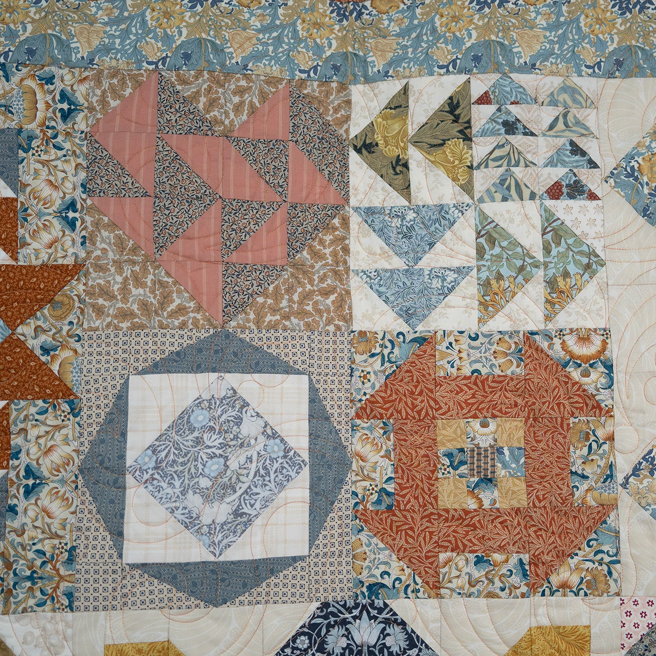 Patchwork quilt with various geometric patterns and colors
