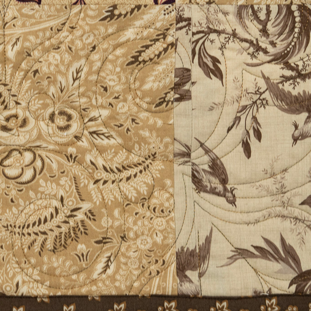 Textile with intricate floral and bird pattern on a beige background