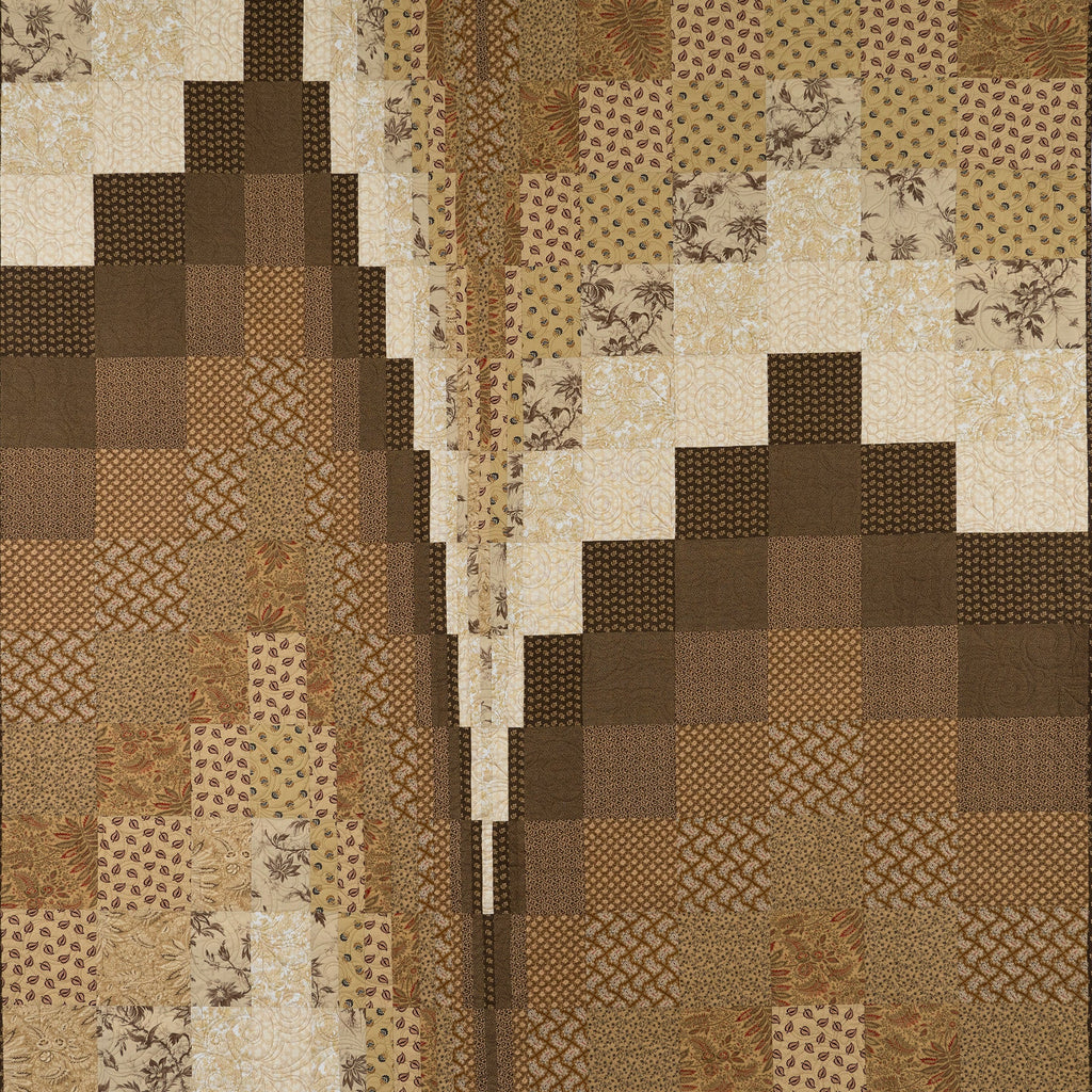 Patchwork quilt with brown and beige patterns