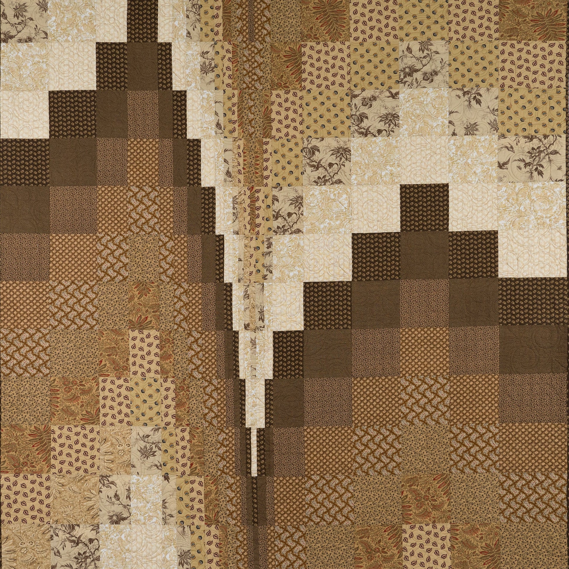 Patchwork quilt with brown and beige patterns