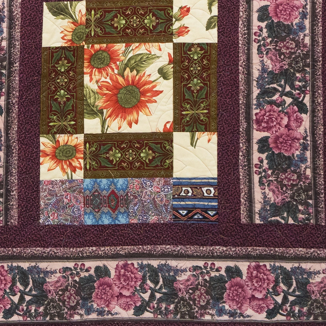 Quilt with floral and geometric patterns on a dark background