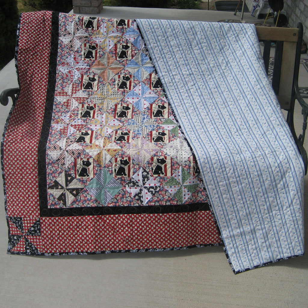 Quilt with a pattern draped over a chair outdoors