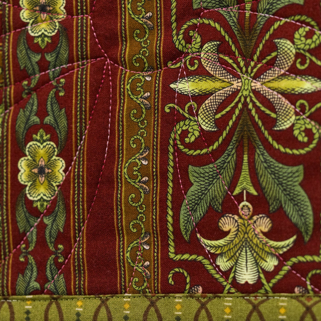 Decorative fabric with intricate patterns and embroidery on a red background