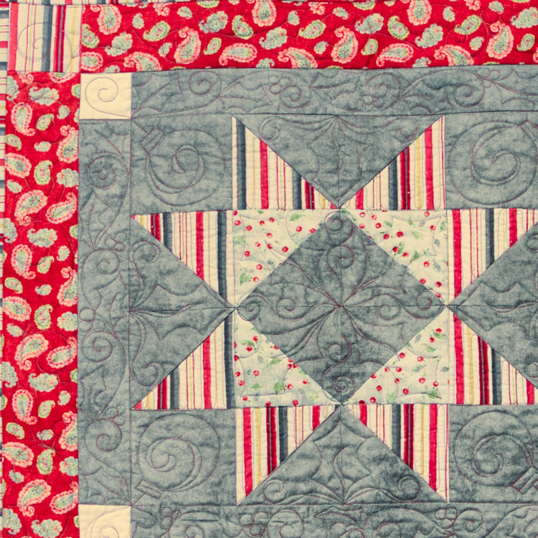 Quilt block with geometric pattern on a red background