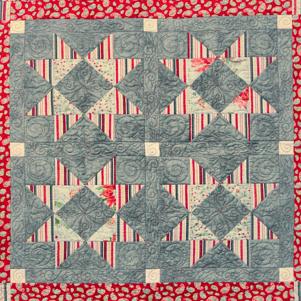 Quilt with geometric pattern on a red background