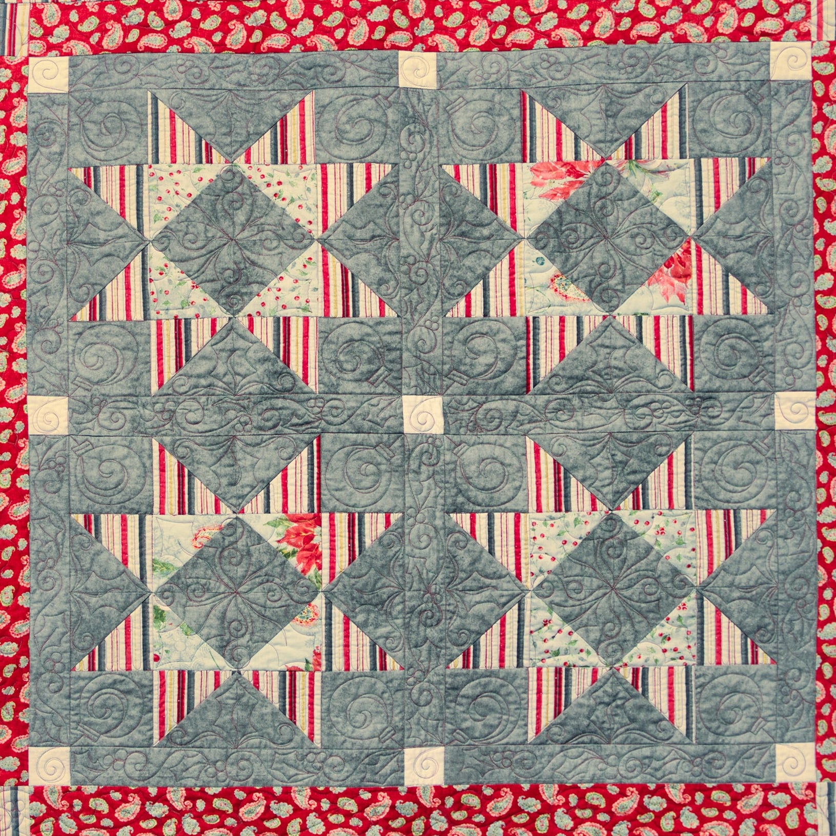 Quilt with geometric pattern on a red background