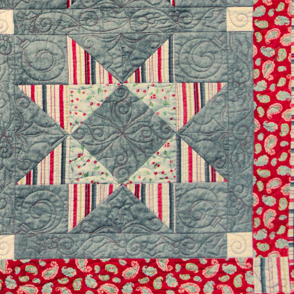 Quilt block with geometric pattern on a red border