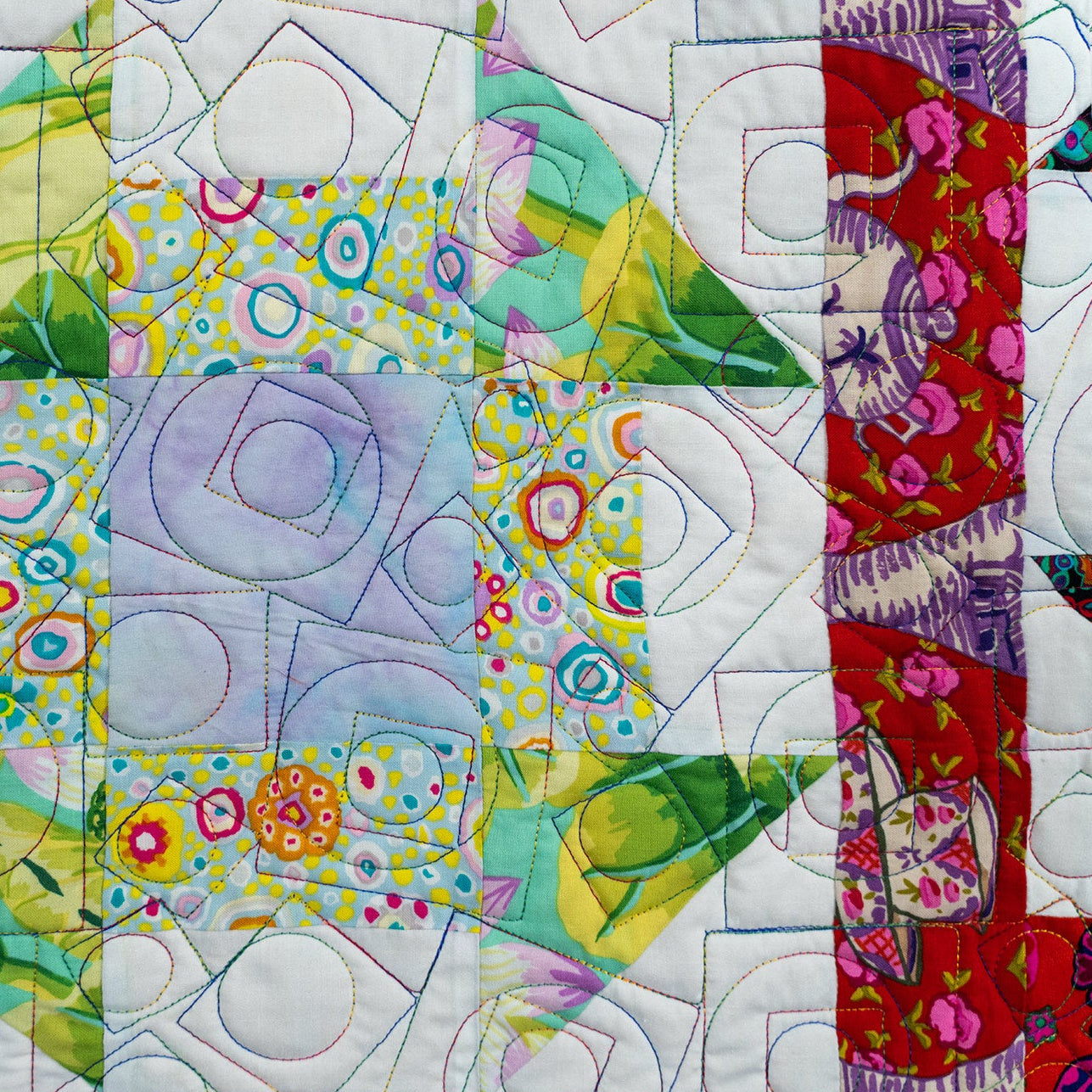 Colorful quilt with geometric patterns and vibrant colors