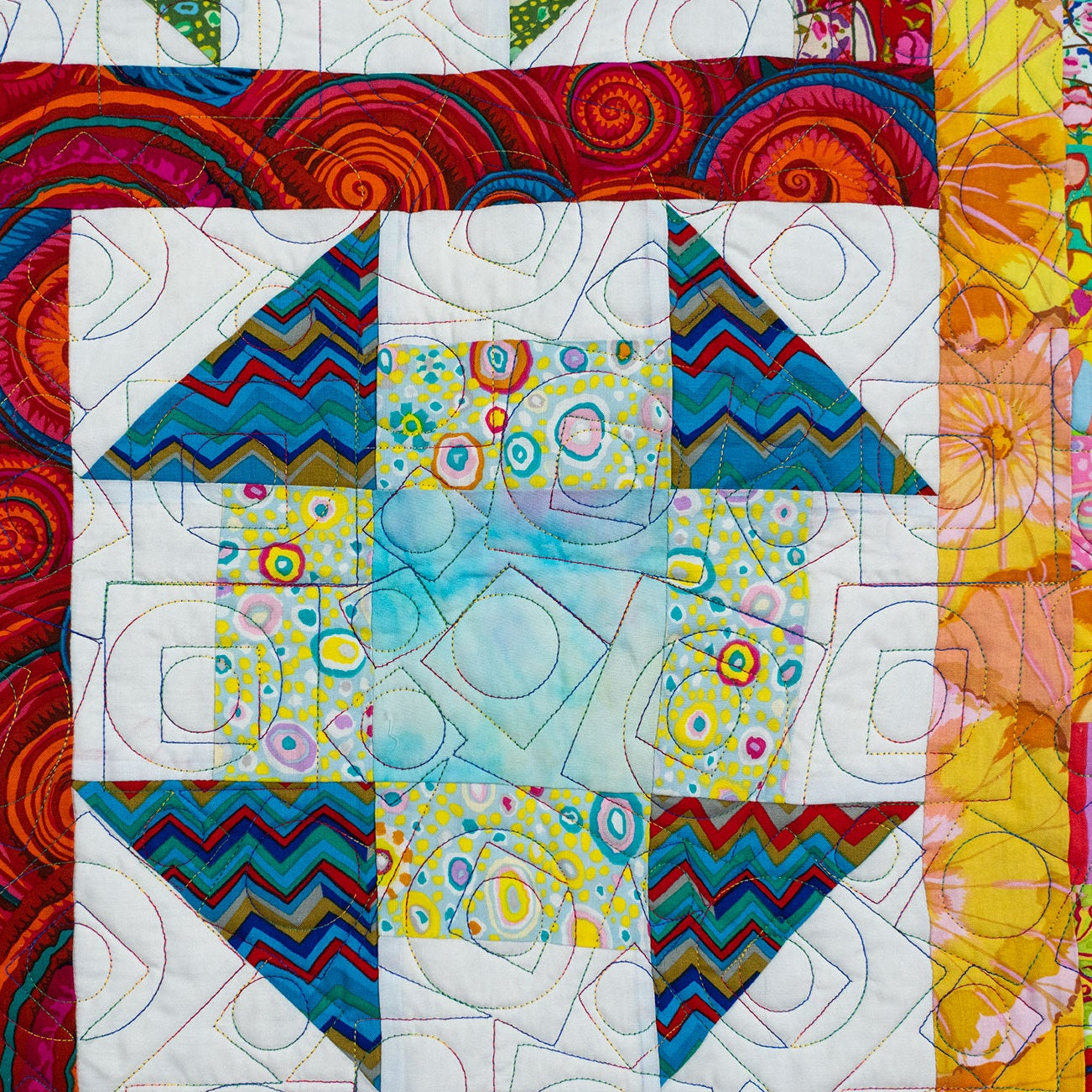 Colorful quilt with geometric patterns and vibrant colors