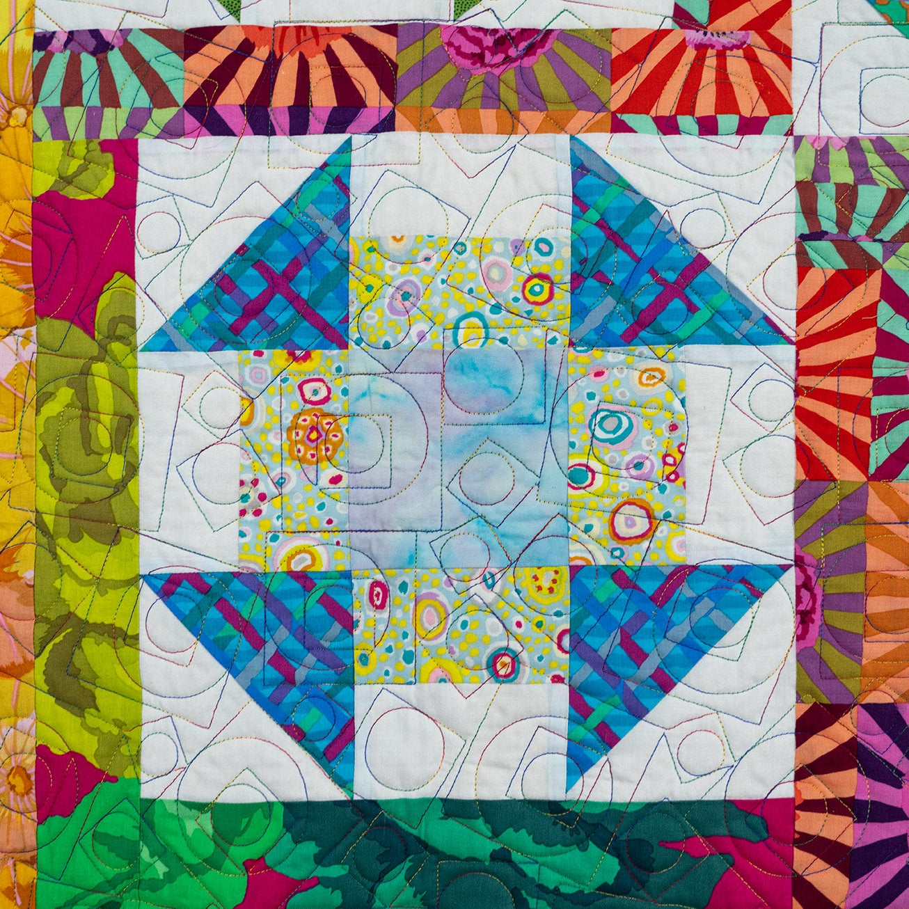 Colorful quilt with geometric patterns and vibrant colors