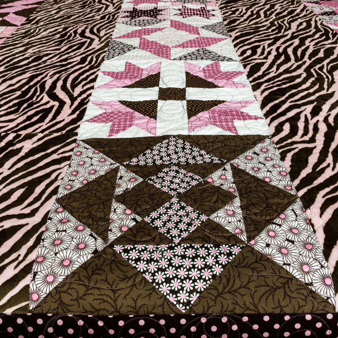 Quilt block with a geometric centre print with animal print border in pink and brown