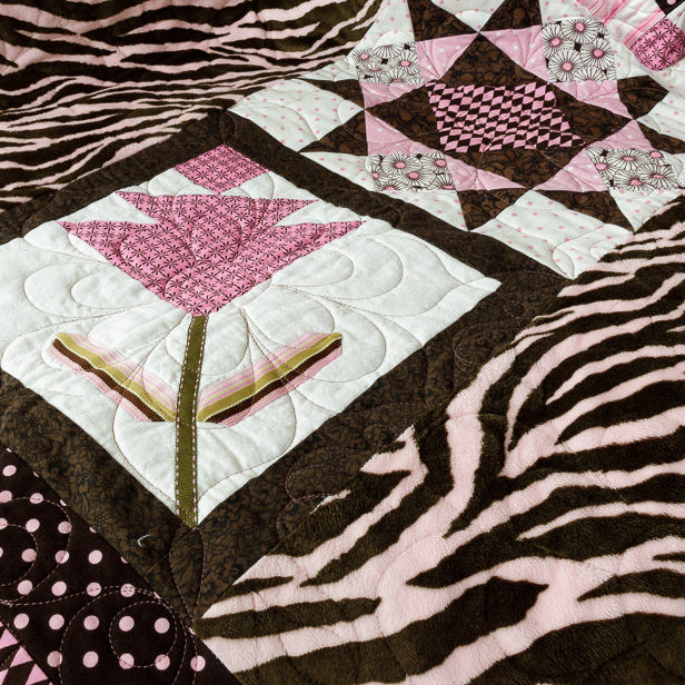 Quilt block with a geometric centre print with animal print border in pink and brown