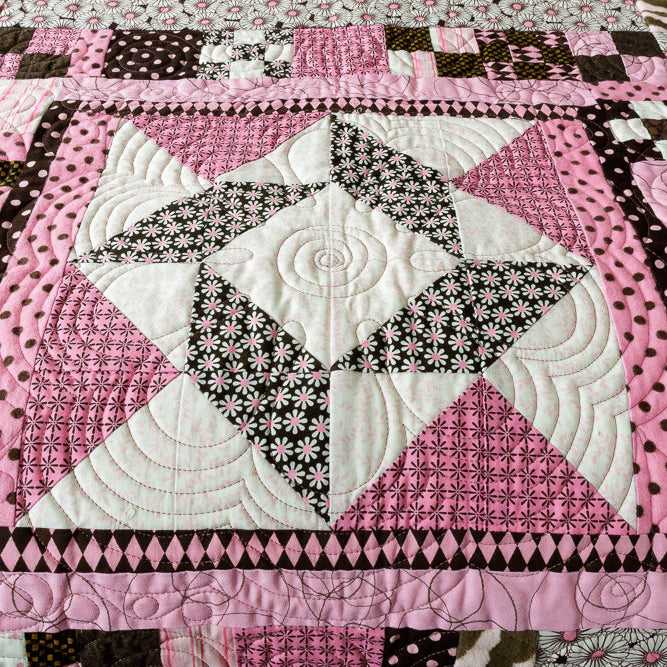 Wall hanging in a floral and geometric pattern in pink and brown