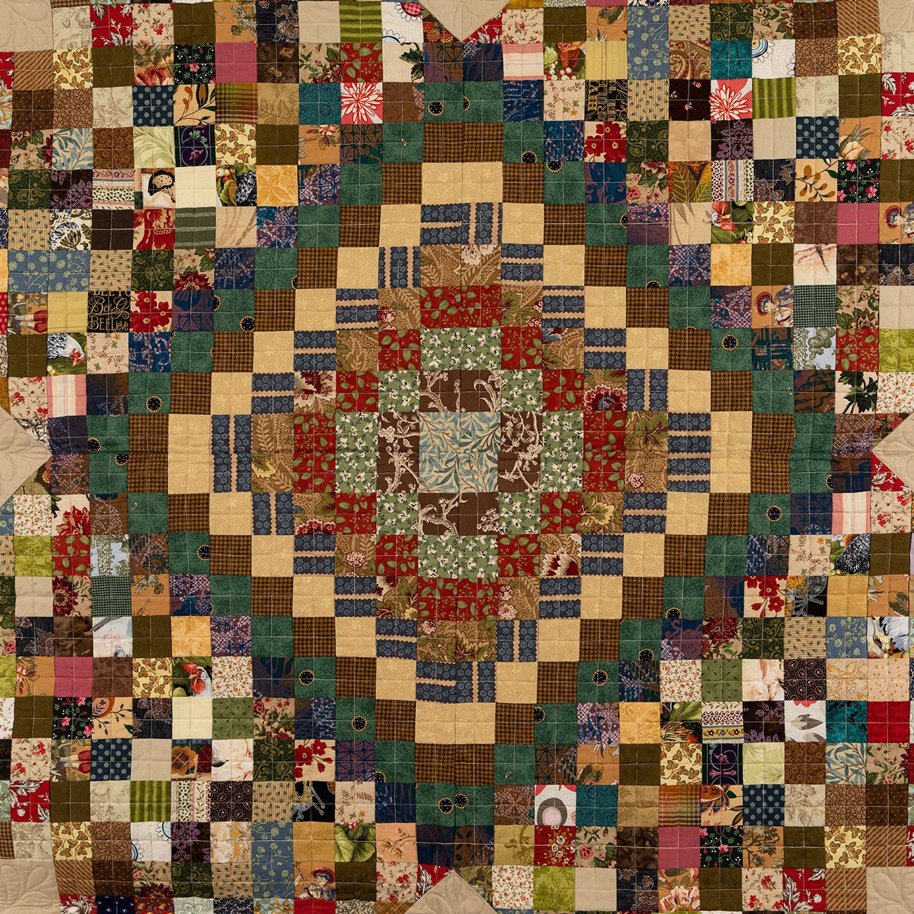 Patchwork quilt with multicolored squares and a beige border