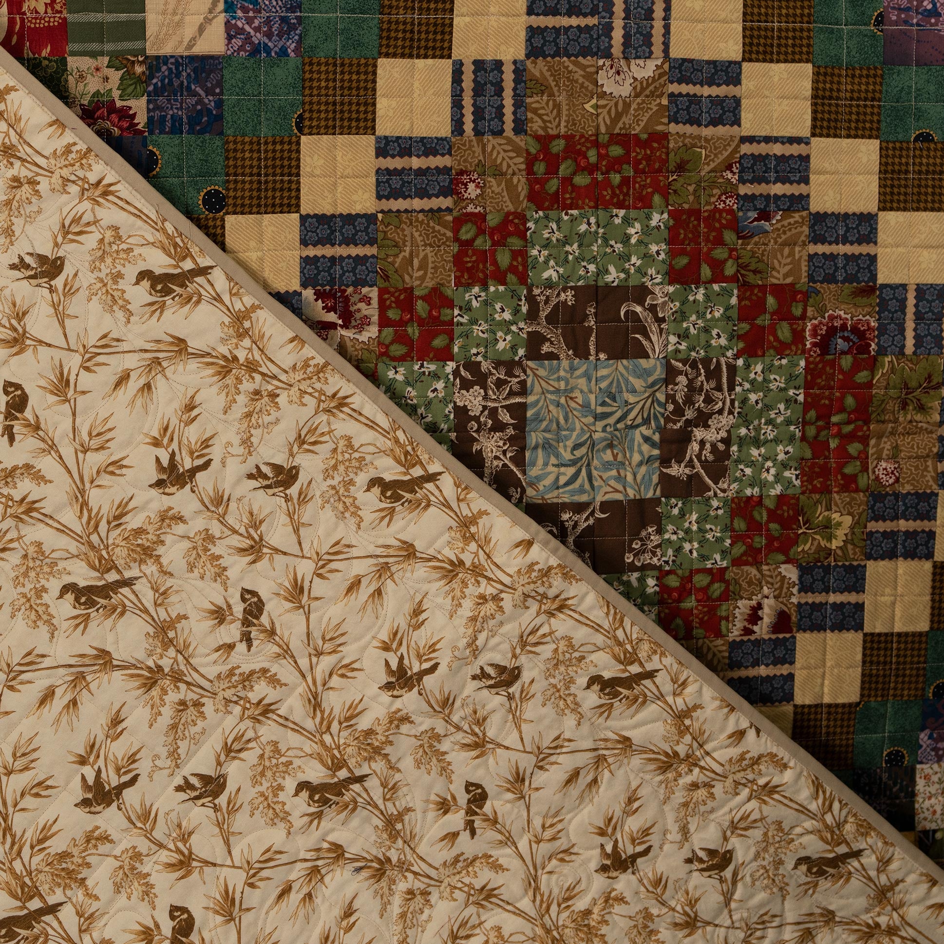 Two different fabric patterns side by side, one with bird and floral design and the other a patchwork pattern.