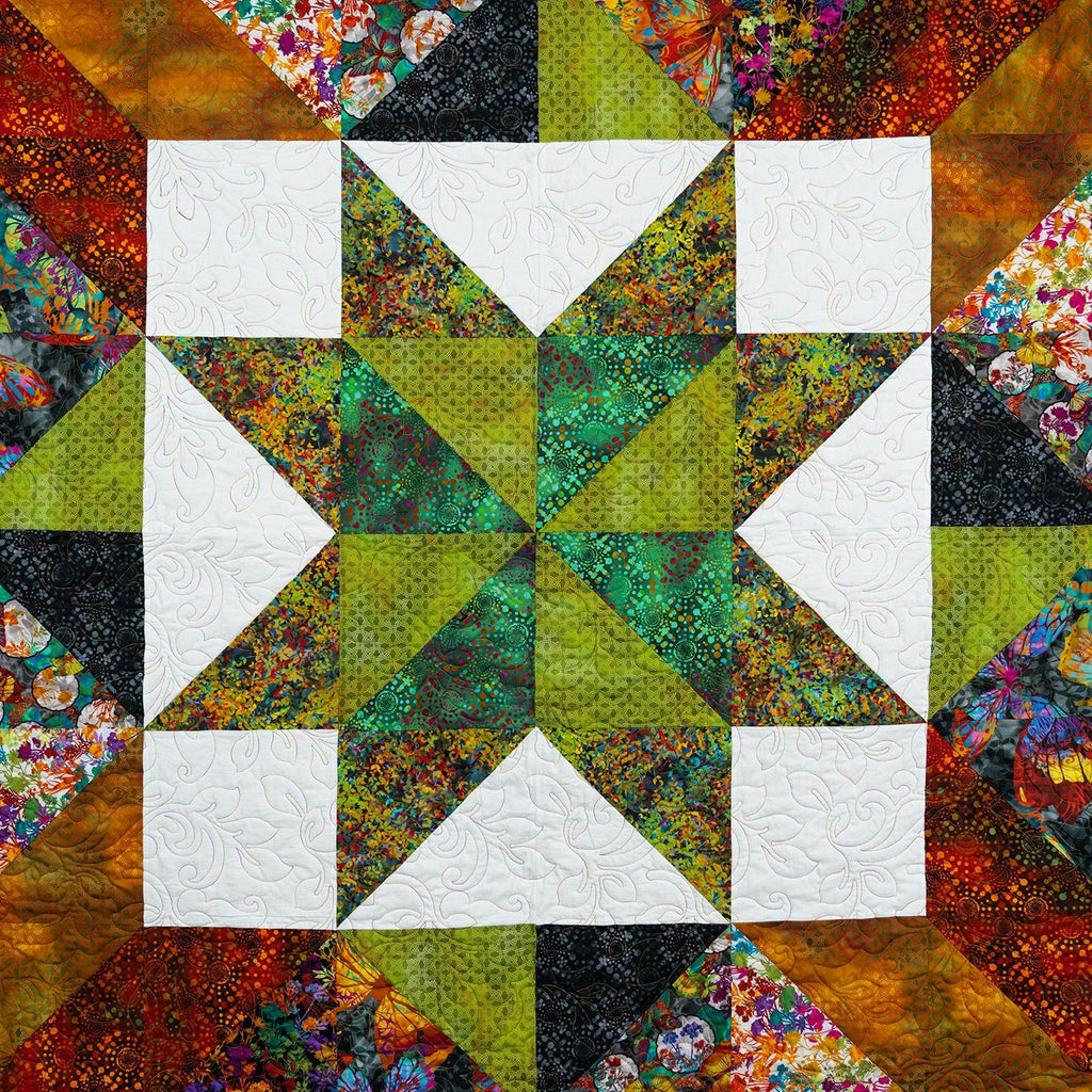 Colorful quilt with geometric pattern featuring triangles and squares.