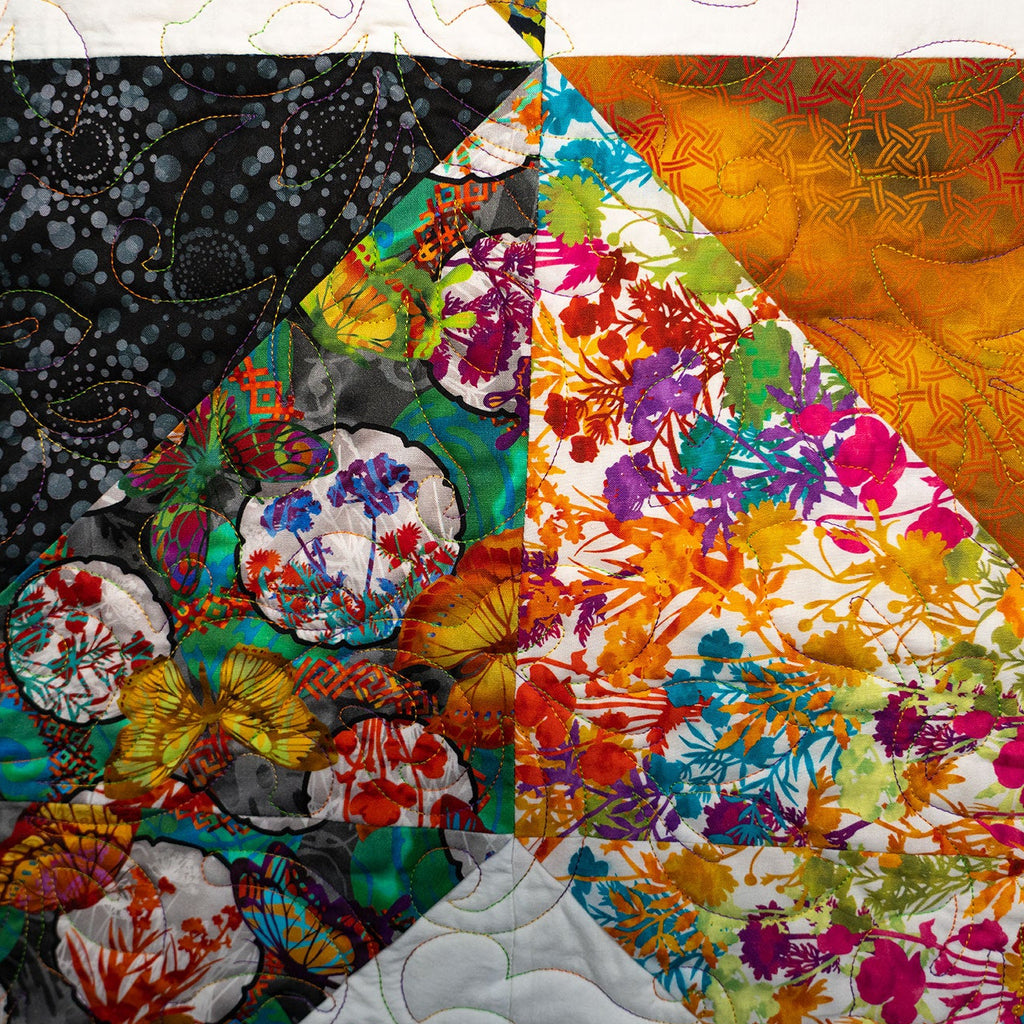 Colorful quilt with floral patterns in various colors