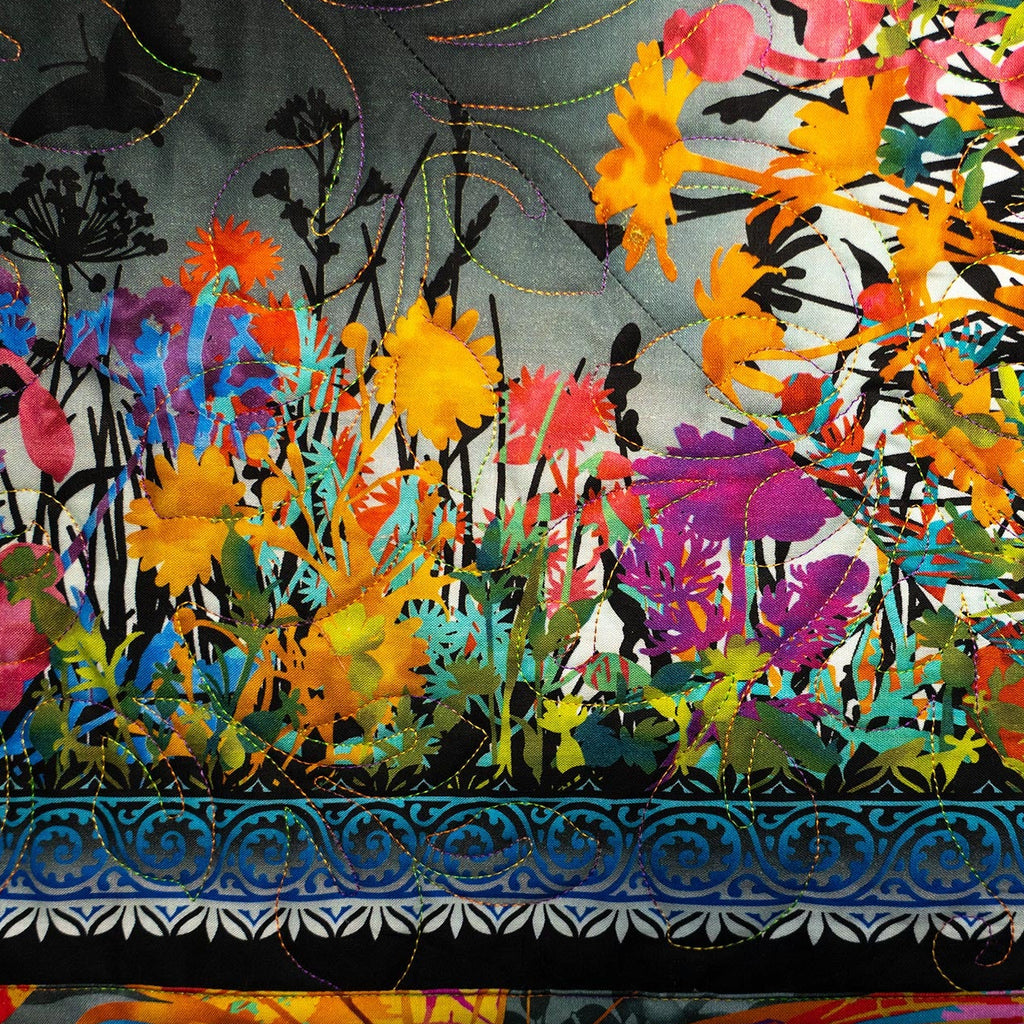 Colorful floral quilt with intricate patterns and vibrant colors.