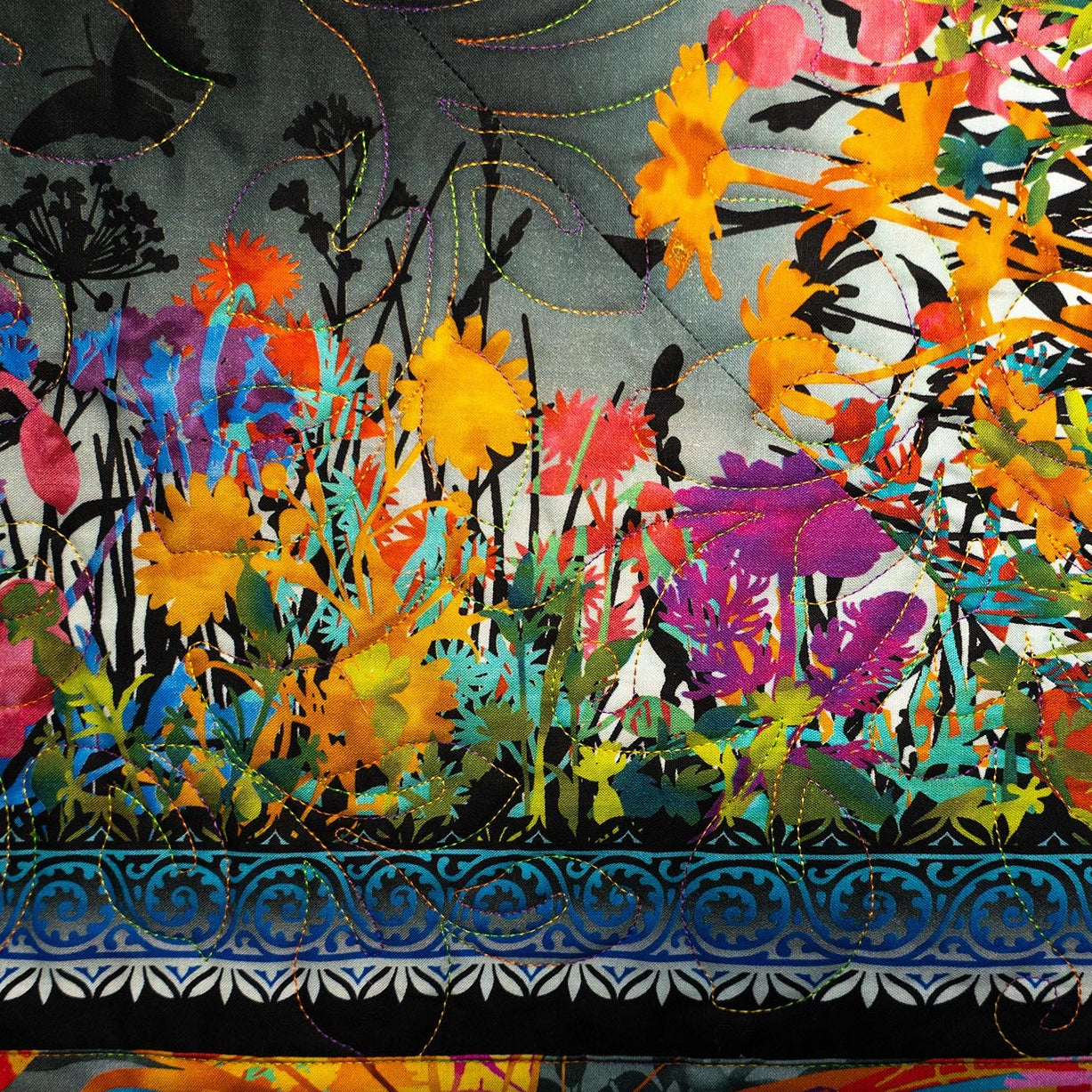 Colorful floral quilt with intricate patterns and vibrant colors.