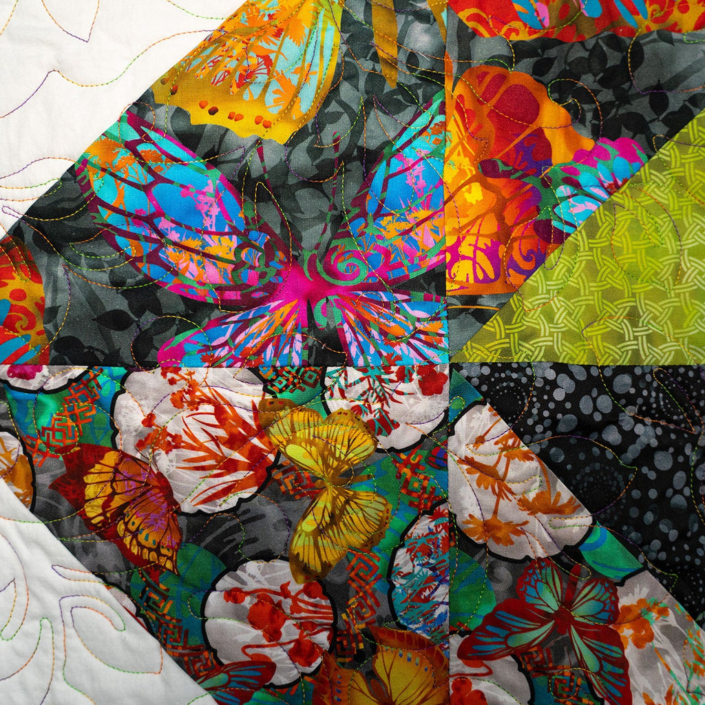 Colorful butterfly and floral patterned fabric swatch