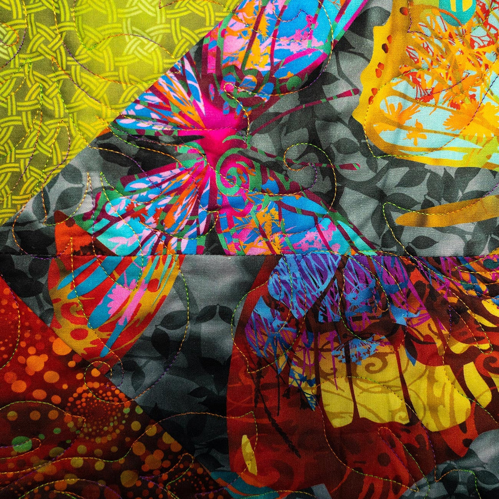 Colorful abstract quilt with various patterns and vibrant colors.