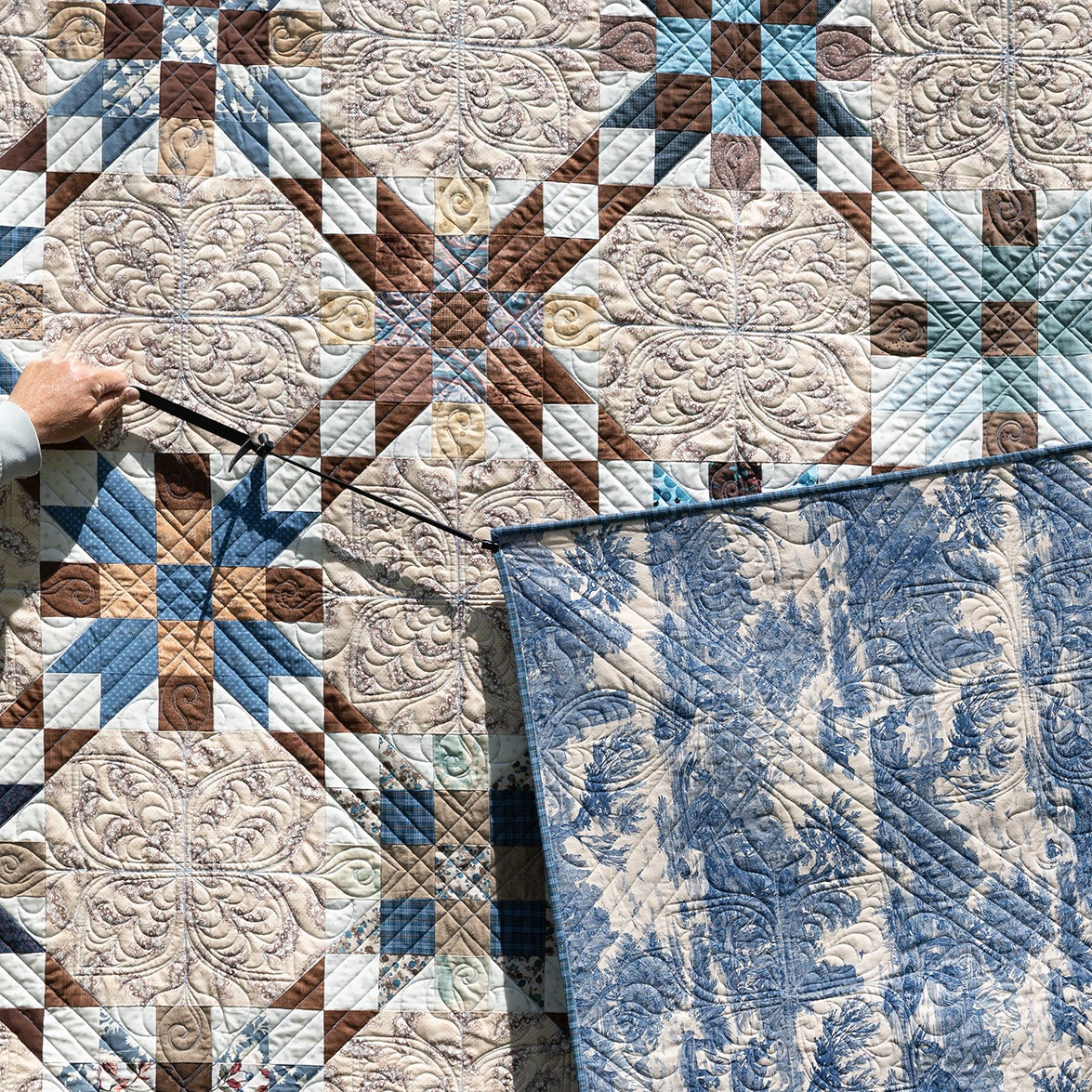 Two patterned quilts, one with geometric design and the other with floral design.