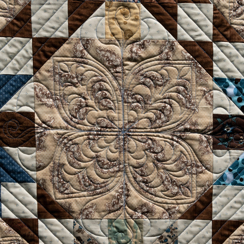 Close-up of a quilt with intricate patterns and colors