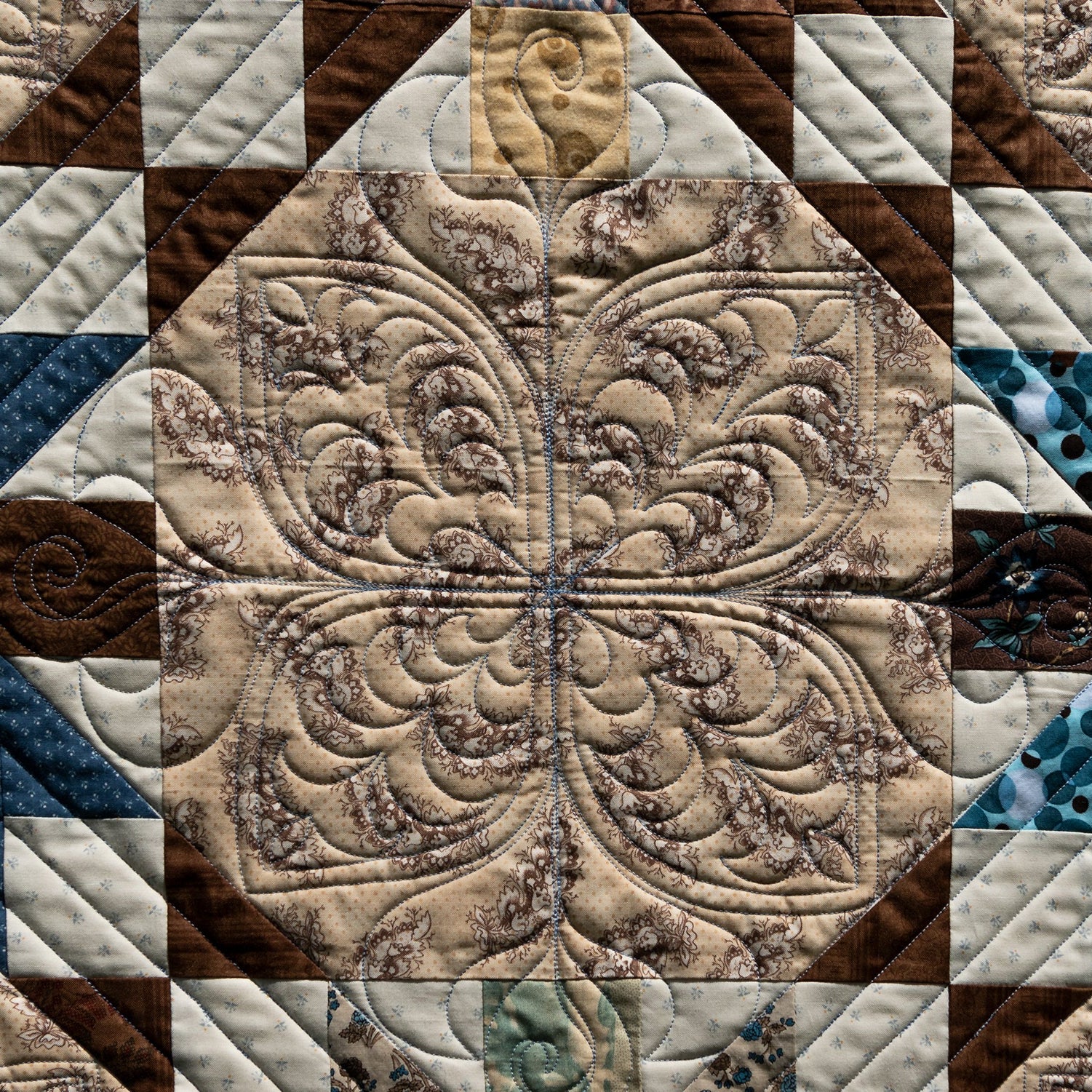Close-up of a quilt with intricate patterns and colors