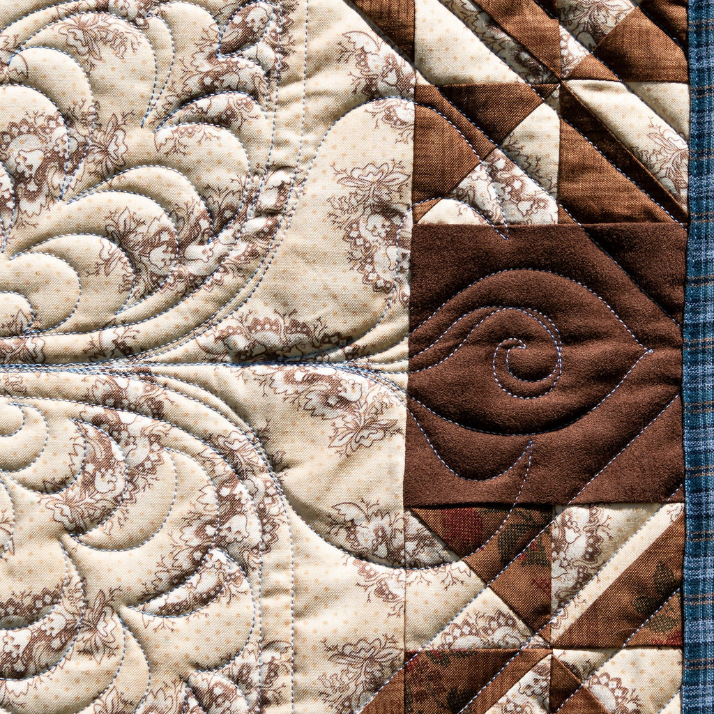 Close-up of a quilt with intricate patterns and textures.