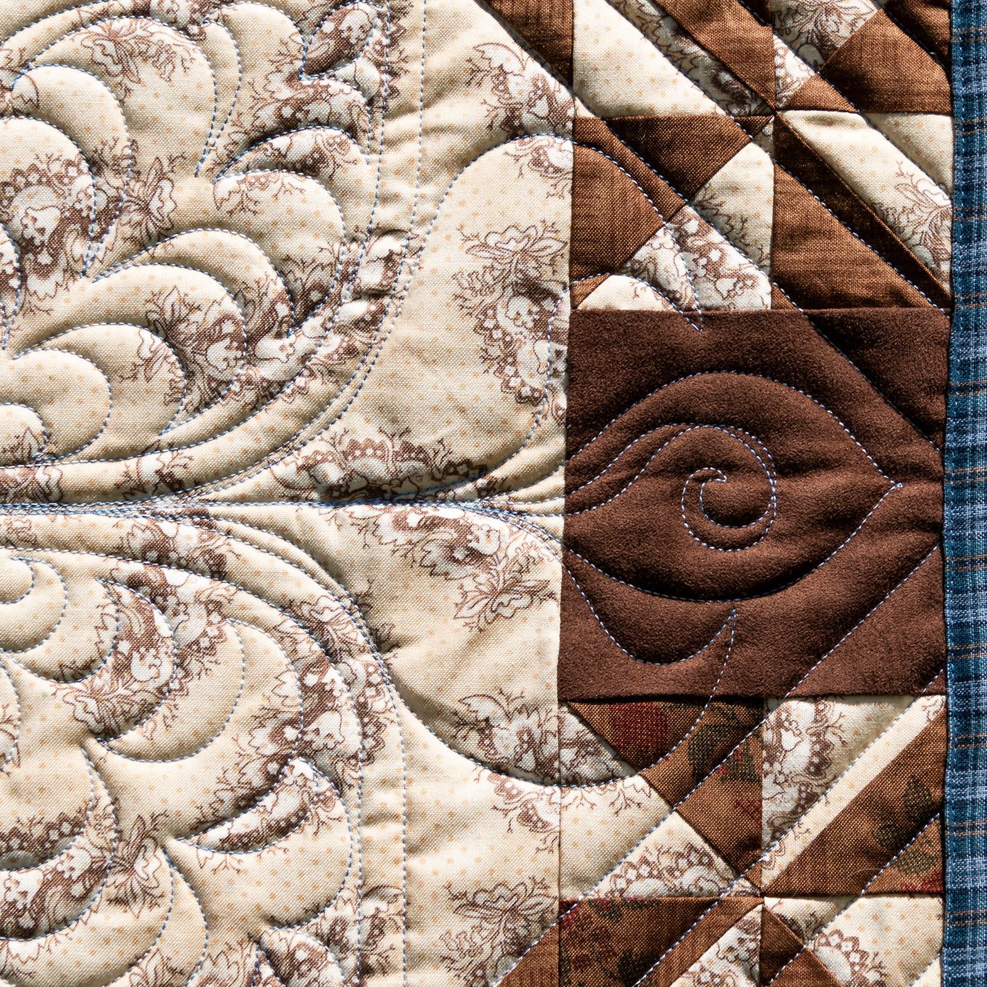 Close-up of a quilt with intricate patterns and textures.