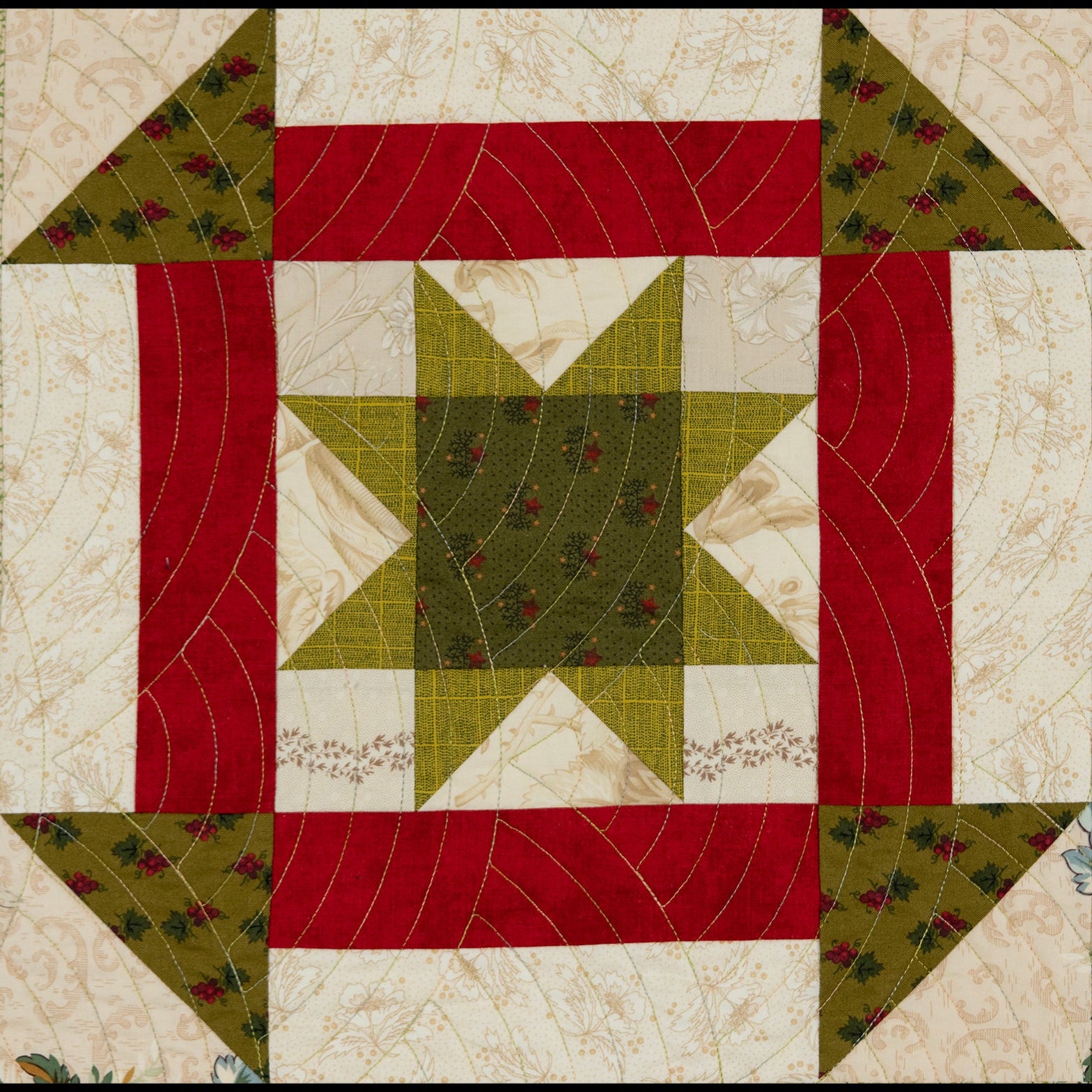 Quilt block with a large churn dash print in red and green