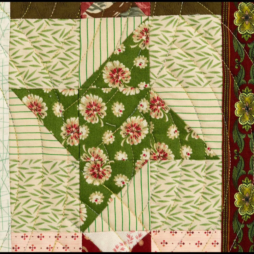 Quilt block with various floral prints in green tones