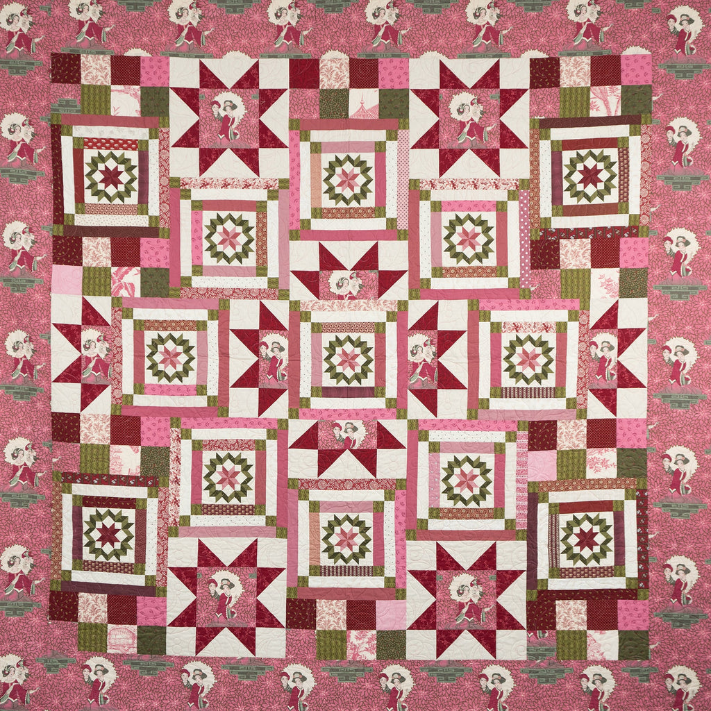 Pink geometric and star printed quilt laid out with empress figures around the border