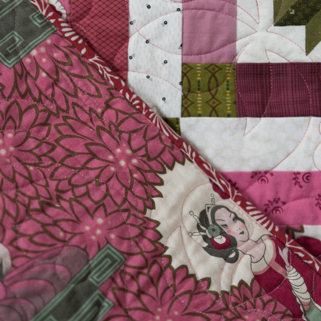 Quilt backing with a floral and empress print in pink with a leaf print border