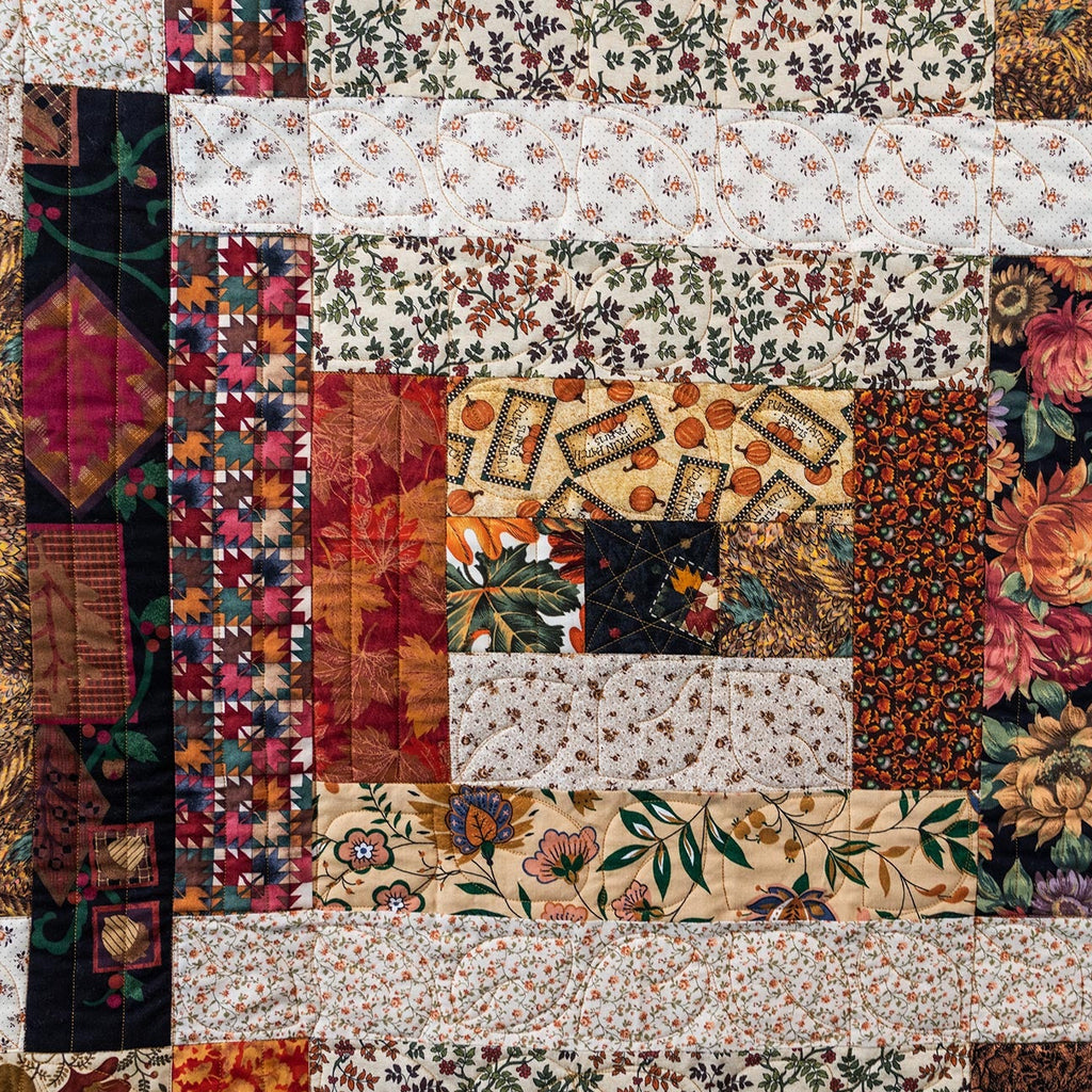 Colorful patchwork quilt with floral and geometric patterns